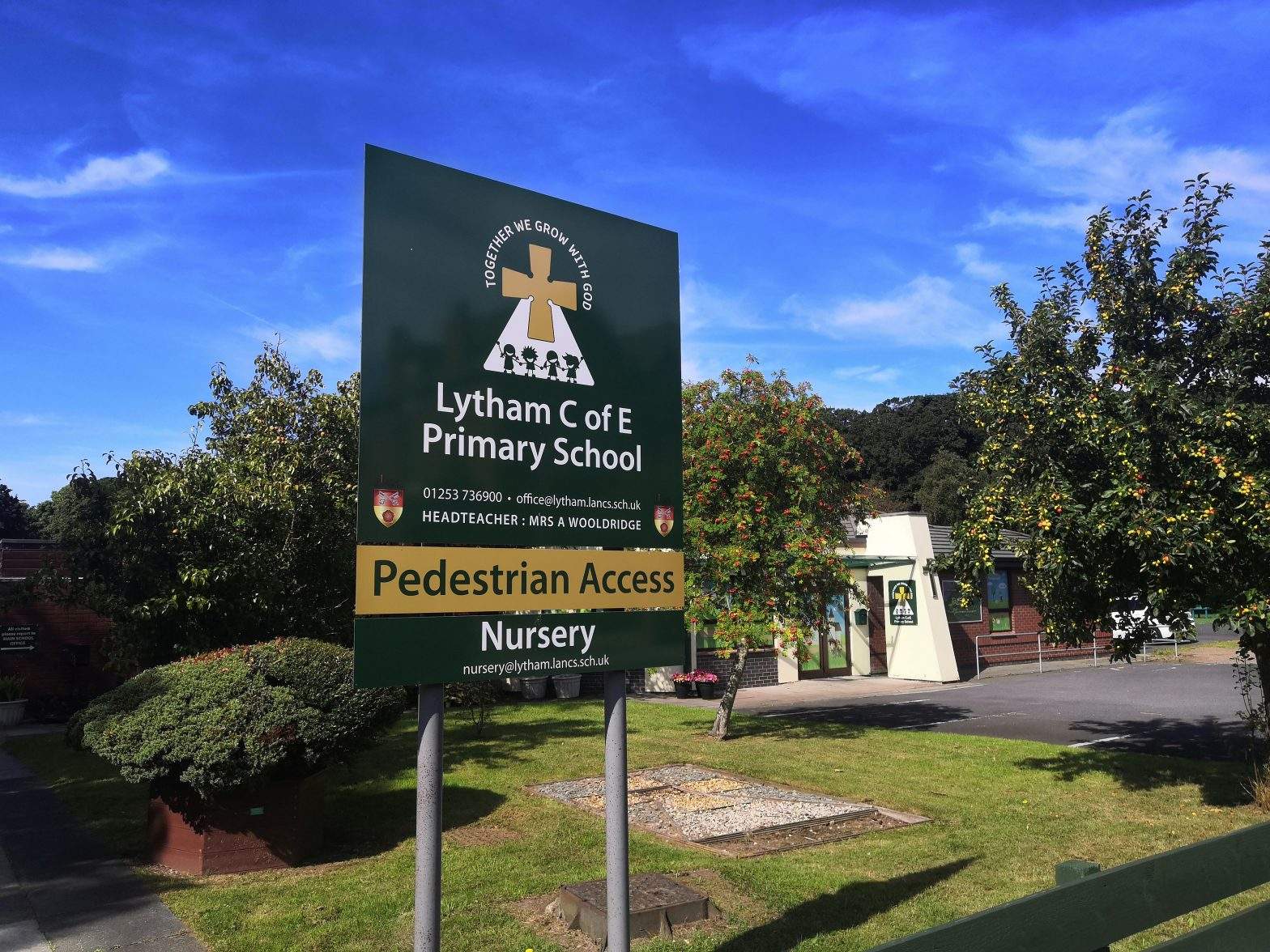 The sign outside Lytham C of E Primary school on a sunny day. The school can be seen in the background.