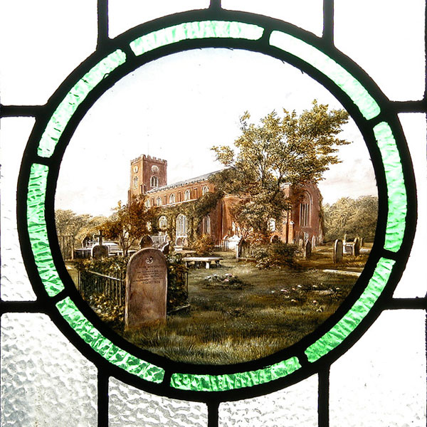 A window depicting St Cuthbert's church and front churchyard set in a circle of green glass and surrounded by leaded panes of clear, hammered glass.